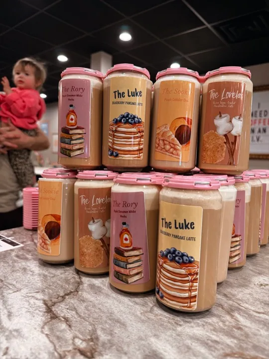Gilmore Girls-inspired drinks labeled The Rory, The Luke, The Sookie and The Lorelai, lined up on the cafe counter