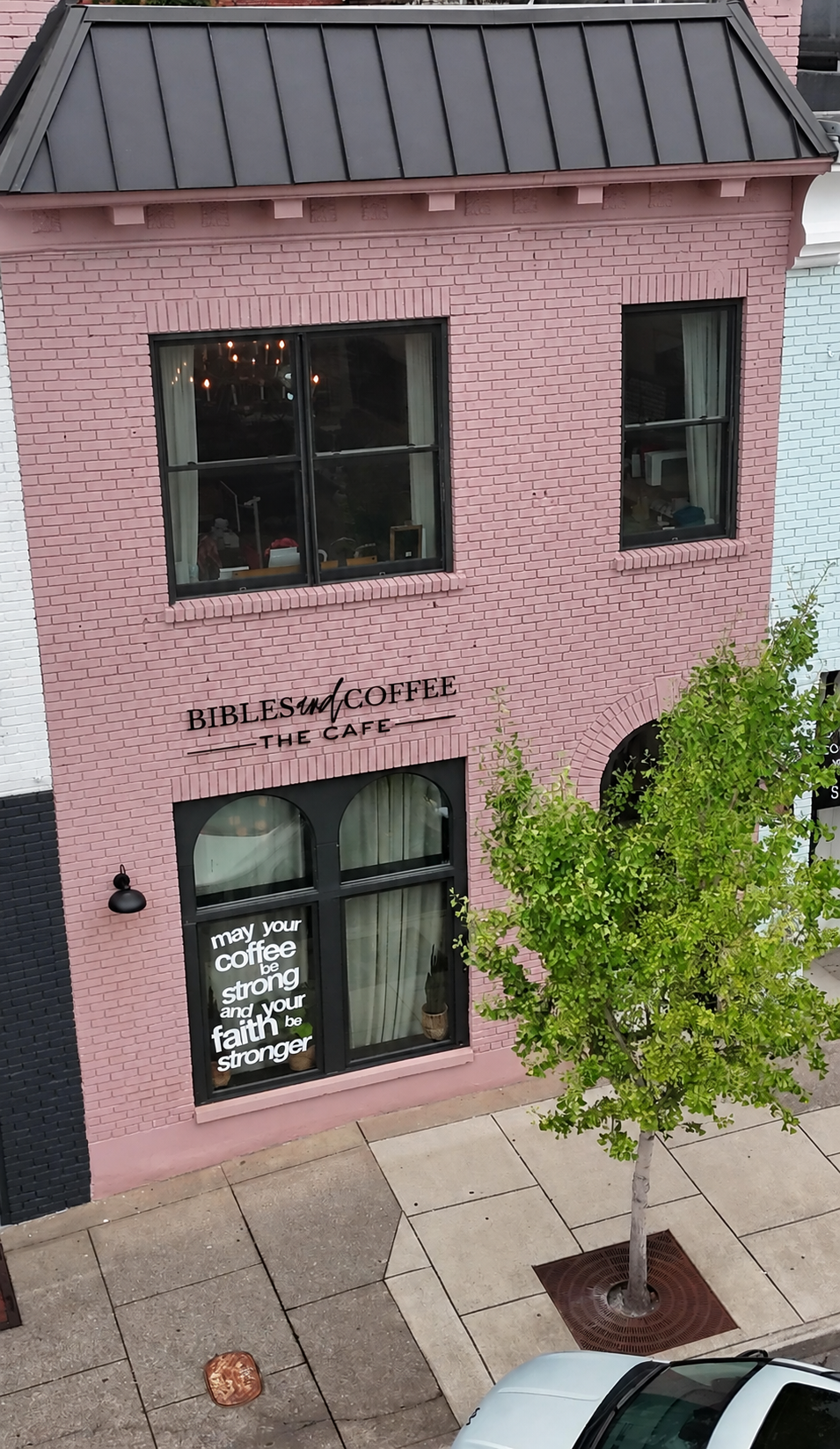 The pink storefront of Bibles and Coffee Cafe in downtown Murfreesboro